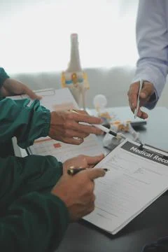 Group of doctors reading a document in meeting room at hospital Stock Photos