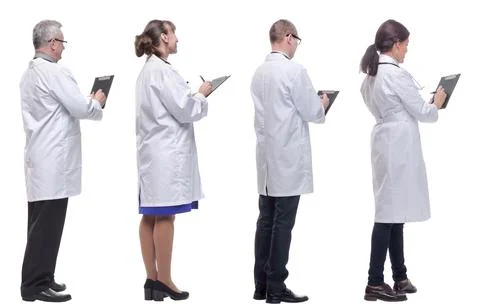 Group of doctors standing with their backs isolated on white Foto stock