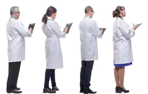 Group of doctors standing with their backs isolated on white 스톡 사진