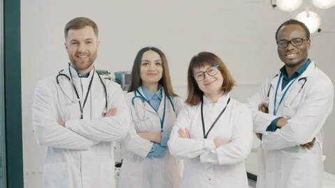 Group of doctors standing together and cross their arms in medical clinic Stock Footage 276546637