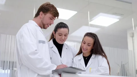 Group of doctors watching document on notepad Stock Footage 255196429