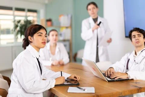 Group of doctors watching presentation at table Stock Photos