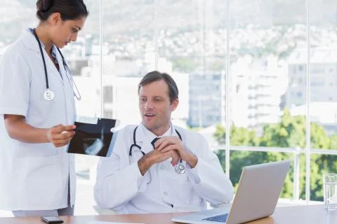 Group of doctors working on a x ray Stock Photos