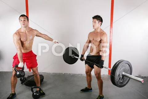 Group with dumbbell weight training equipment on sport gym Stock Photos