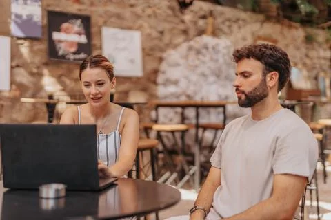 A group of e-commerce professionals strategizing at a cafe bar, discussing Stock Photos