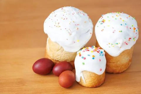 Group of Easter cakes and painted red eggs on a wooden board Stock Photos