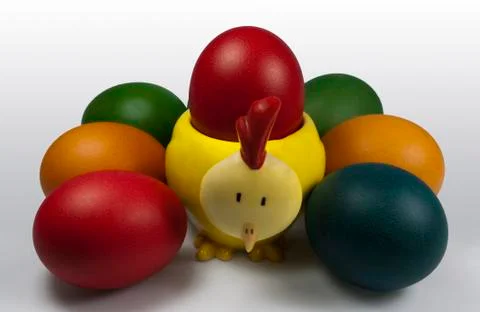 Group of Easter Eggs with Chick Egg holder carrying Red Egg Foto stock