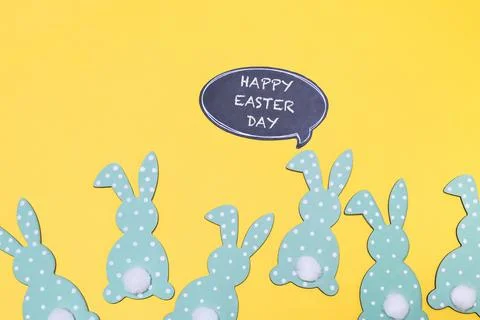 Group of Easter rabbits are standing in a row on a yellow background 스톡 사진
