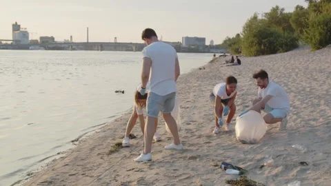 Group of eco-activist cleans garbage in nature. Young people collecting Stock Footage 246811189