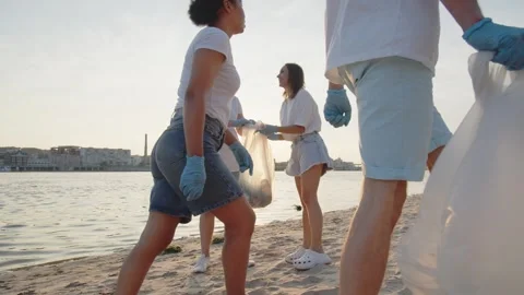 Group of eco-activist cleans garbage in nature. Young people collecting Stock Footage 250805377