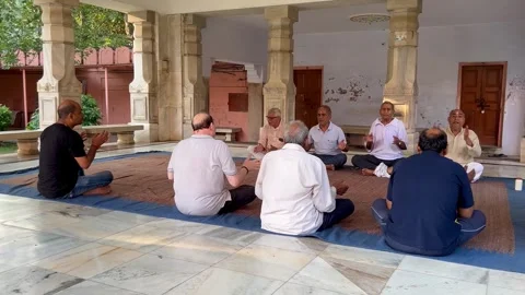 A group of elder devotees sitting in an Indian temple Stock Footage 285025823