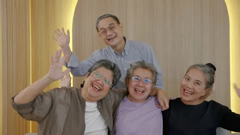 Group of elderly friends are waving to their friends on social media. Stock Footage 220294595