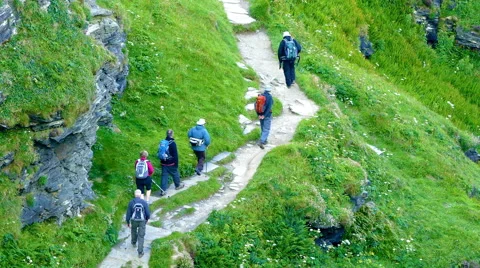 A group of elderly hikers walking up a hillside path in Cornwall. Stock-Footage 66685721