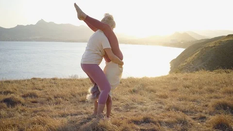 Group of elderly people doing yoga at sunset Stock Footage 123075599