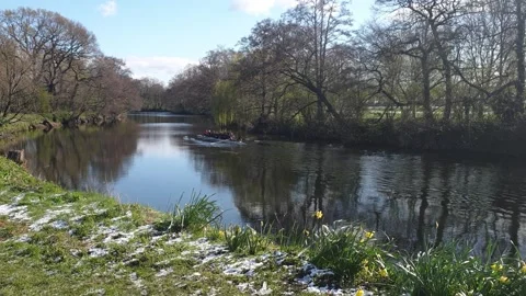 Group of Elderly People Rowing in the River on a Sunny Spring morning after snow Stock Footage 152319553