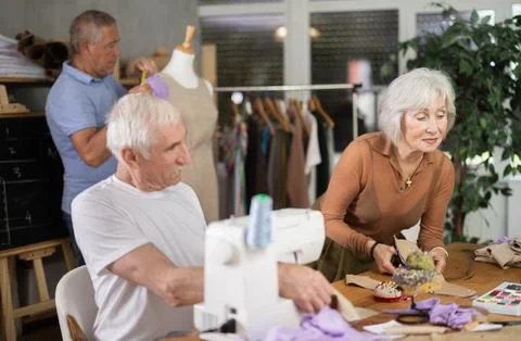 Group of elderly people at sewing master class Stock Photos