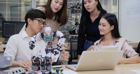 Group of electronics engineer try to fix robot at lab. Stock Footage 111506411