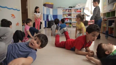 Group of elementary age Schoolchildren Playing on floor Stock Footage 43077610