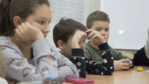 Group of elementary school children in classroom at lesson Stock Footage 82445395