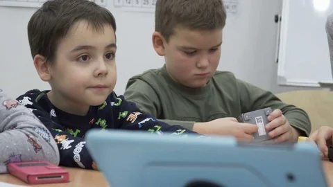 Group of elementary school children in classroom at lesson Stock Footage 82445574