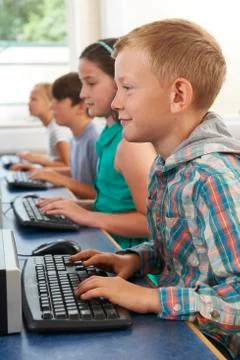 Group of elementary school children in computer class Stock Photos