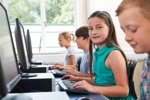 Group of elementary school children in computer class Stock Photos
