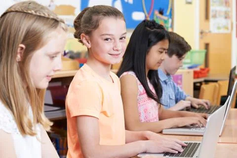 Group Of Elementary School Children In Computer Class Stock Photos