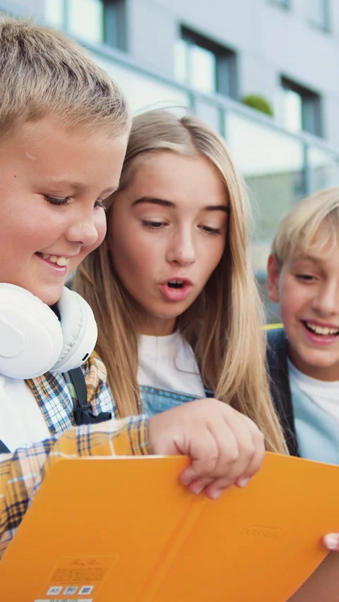 Group of elementary school children writing in their copybooks having an outdoor Stock Footage 331356960