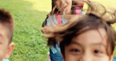 Group of elementary school kids running on the grass Stock Footage 143255952