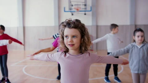Group of elementary students exercising during class at school gym. Stock Footage 194713234