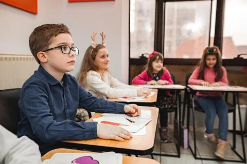 Group of elementary students learning together at language school Stock Photos
