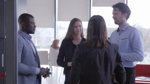 Group of employees chatting together while taking a break Stock Footage 75574221