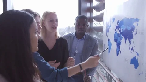 Group of employees explaining their ideas showing places on the map 動画素材 73869486