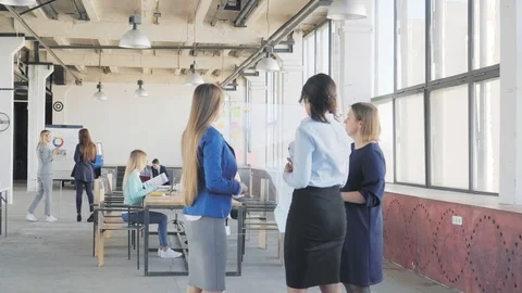 A group of employees working in an office in a loft style. The manager helps to Stock Footage 109504395