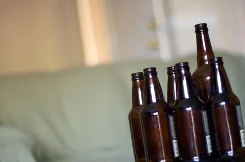Group of empty beer bottles on a table Stock Photos