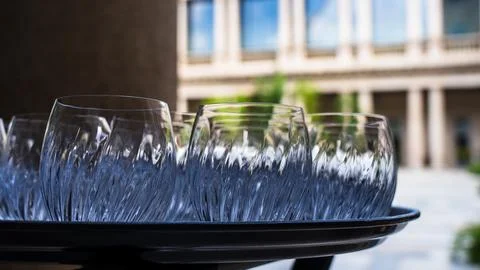 Group of empty worked crystal glasses on a tray Stock Photos