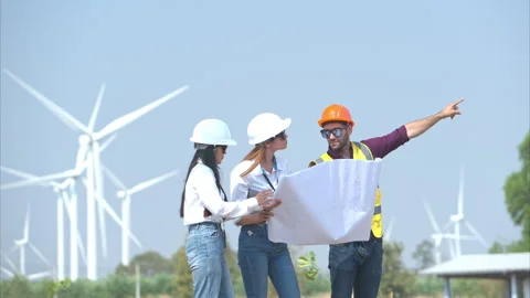 Group of engineers and architects on construction site with wind turbines Stock Footage 264050576