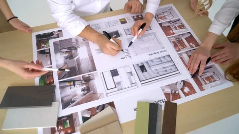 Group engineers and architects discuss the blueprint. Stock Footage 88614996