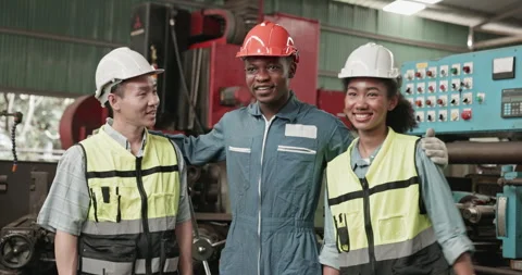 Group of engineers and workers standing happily  while working in a factory Stock Footage 255107152
