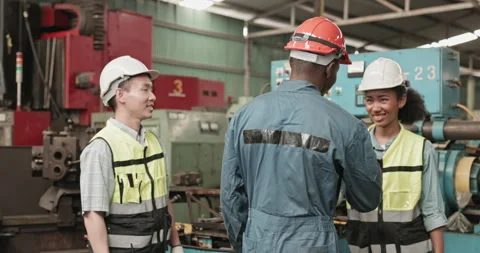 Group of engineers and workers standing happily  while working in a factory Stock Footage 255107380