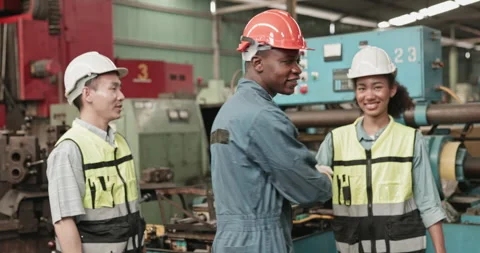 Group of engineers and workers standing happily  while working in a factory Stock Footage 255108461
