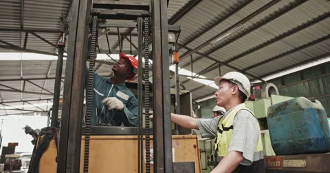 Group of engineers and workers standing happily  while working in a factory Stock Footage 255108918