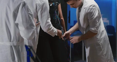 Group of engineers assembling robot control suit Video stock 97672455