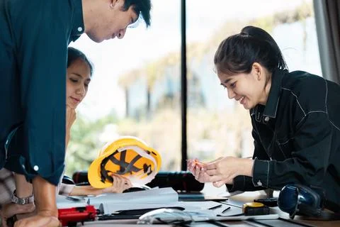 Group of Engineers Collaborating on a Project in a Modern Office Environment Stock Photos