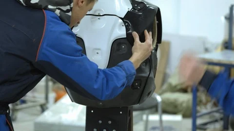 A group of engineers creates a modern robot or android. Check and repair broken Stock Footage 101372596