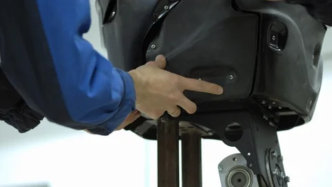 A group of engineers creates a modern robot or android. Check and repair broken Stock Footage 101372864