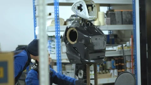 A group of engineers creates a modern robot or android. Check and repair broken Stock Footage 101373339