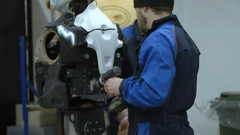 A group of engineers creates a modern robot or android. Check and repair broken Stock Footage 101374097