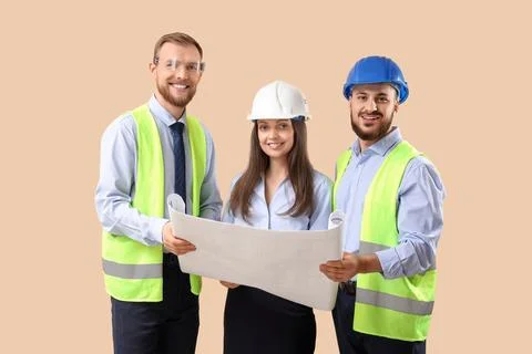 Group of engineers with house plan on beige background Stock Photos