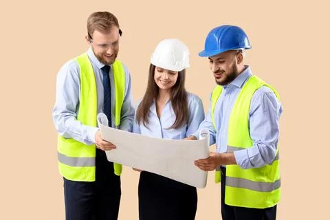 Group of engineers with house plan on beige background Stock Photos